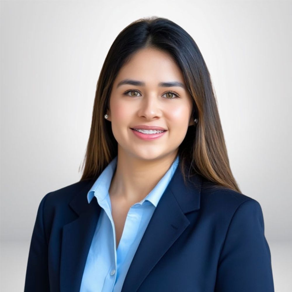 Professional woman in business attire smiling against a neutral background.