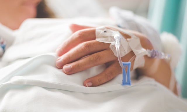 Features / Benefits – Parks Zeigler, PLLC Close up of a Patients Hand with an Iv Drip in a Hospital Bed Symbolizing Healthcare and Recovery