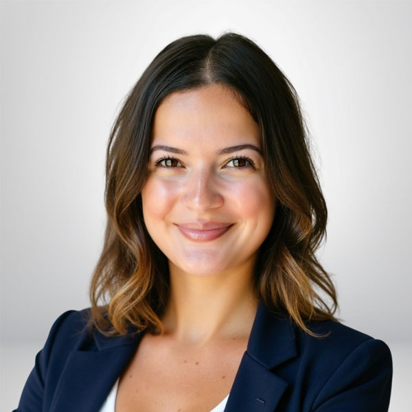 Smiling Woman in a Navy Blazer Against a Neutral Background Conveying Confidence and Professionalism